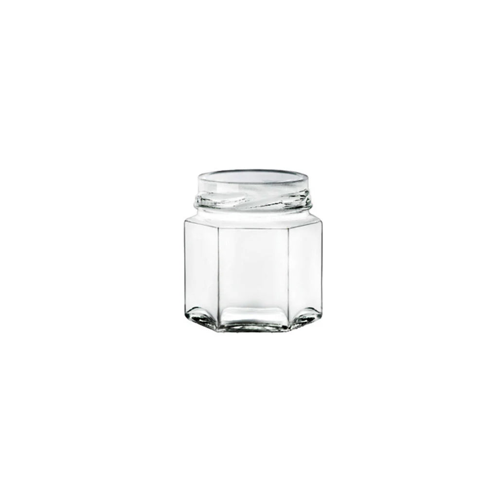 Clear glass hexagonal jar on a white background