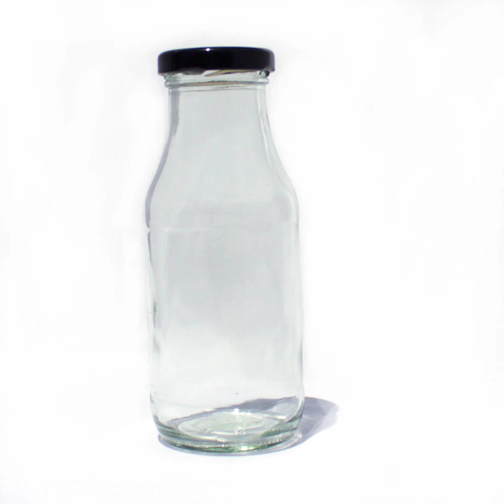 Clear glass bottle with a black lid on a white background
